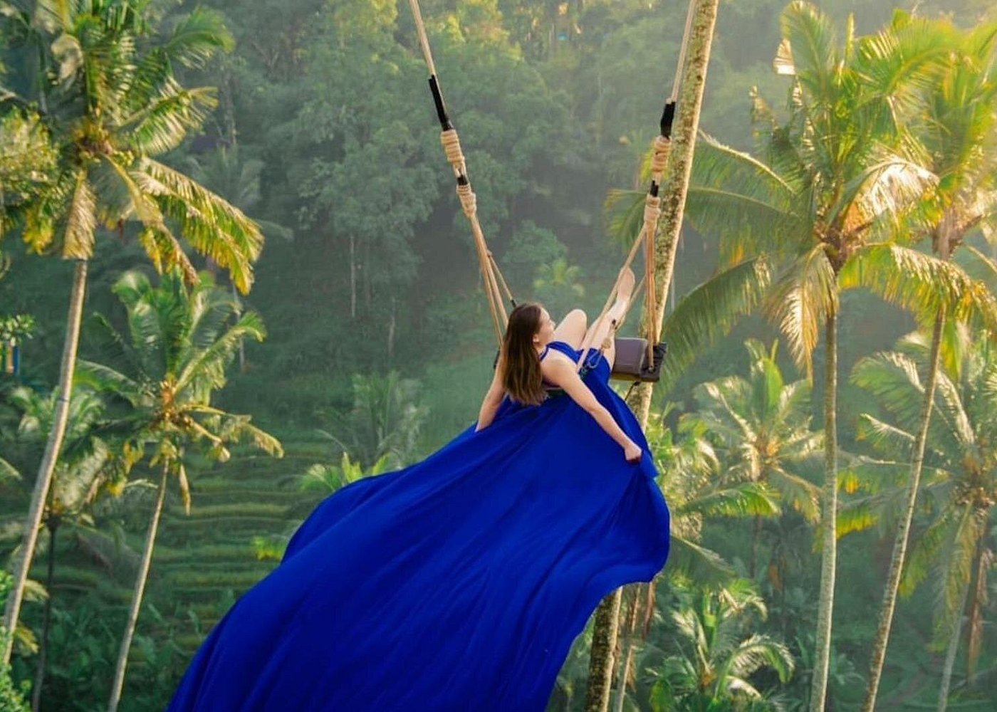 Bali jungle swing soaring out over a tropical valley