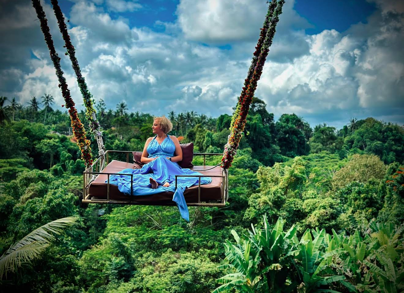 Guests on the Bali jungle swing soaring over coconut palms