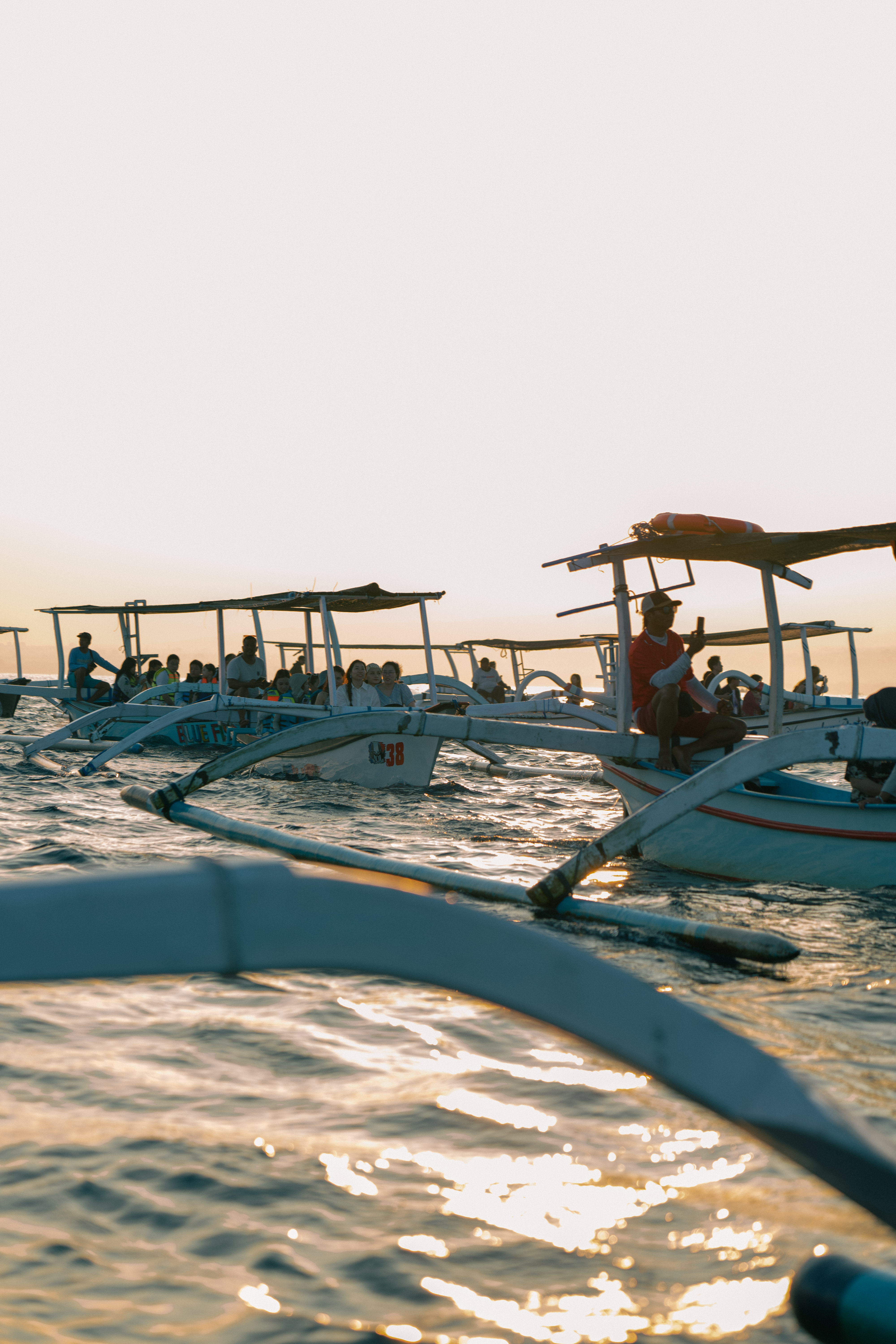 Outrigger fleet at Lovina Beach during golden sunrise