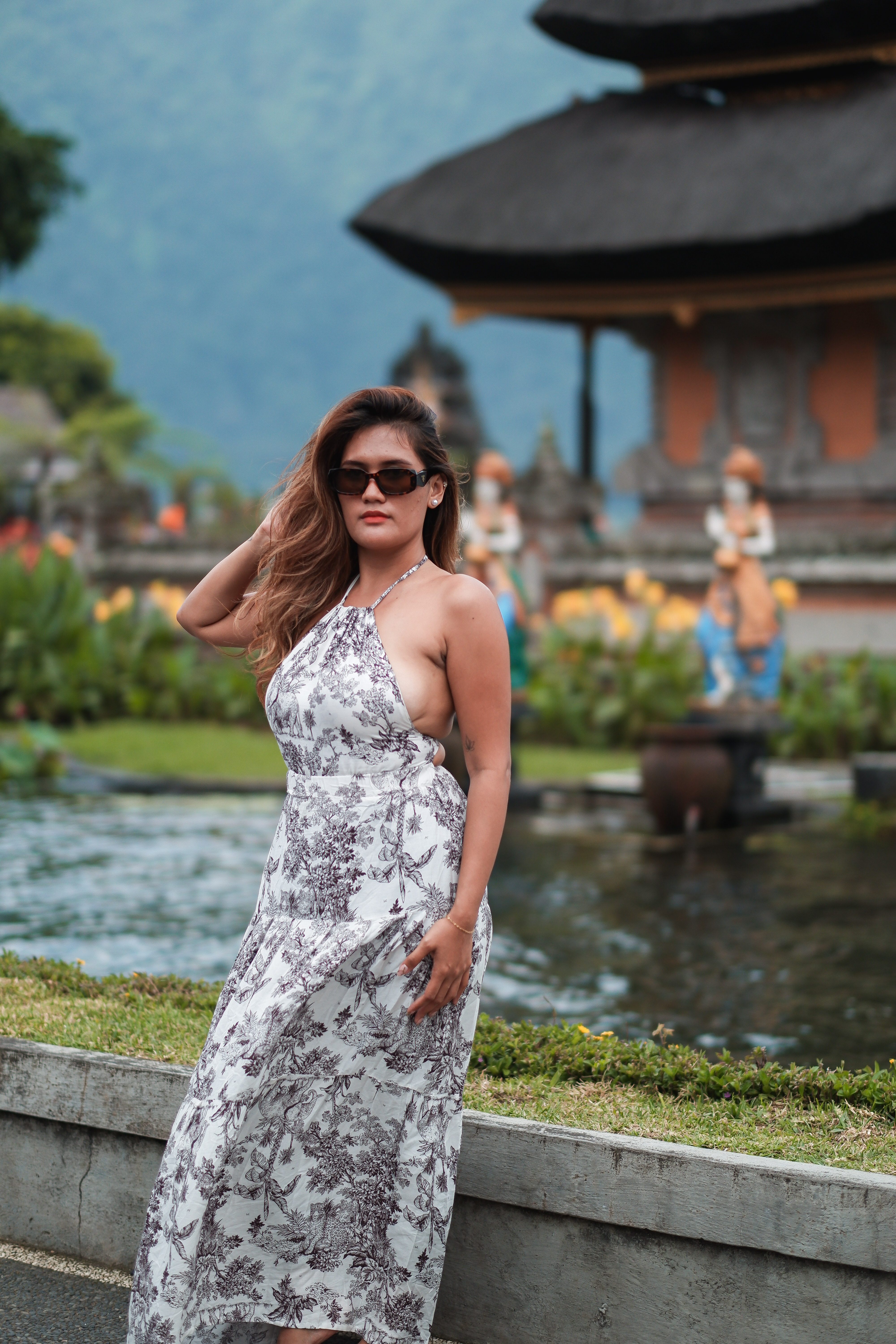 Traveller in floral dress at Ulun Danu Beratan temple, Bedugul