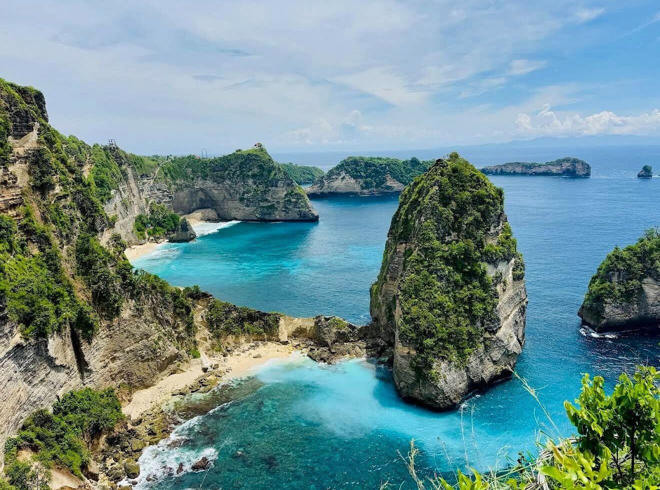 Travellers admiring sea views from a Nusa Penida lookout