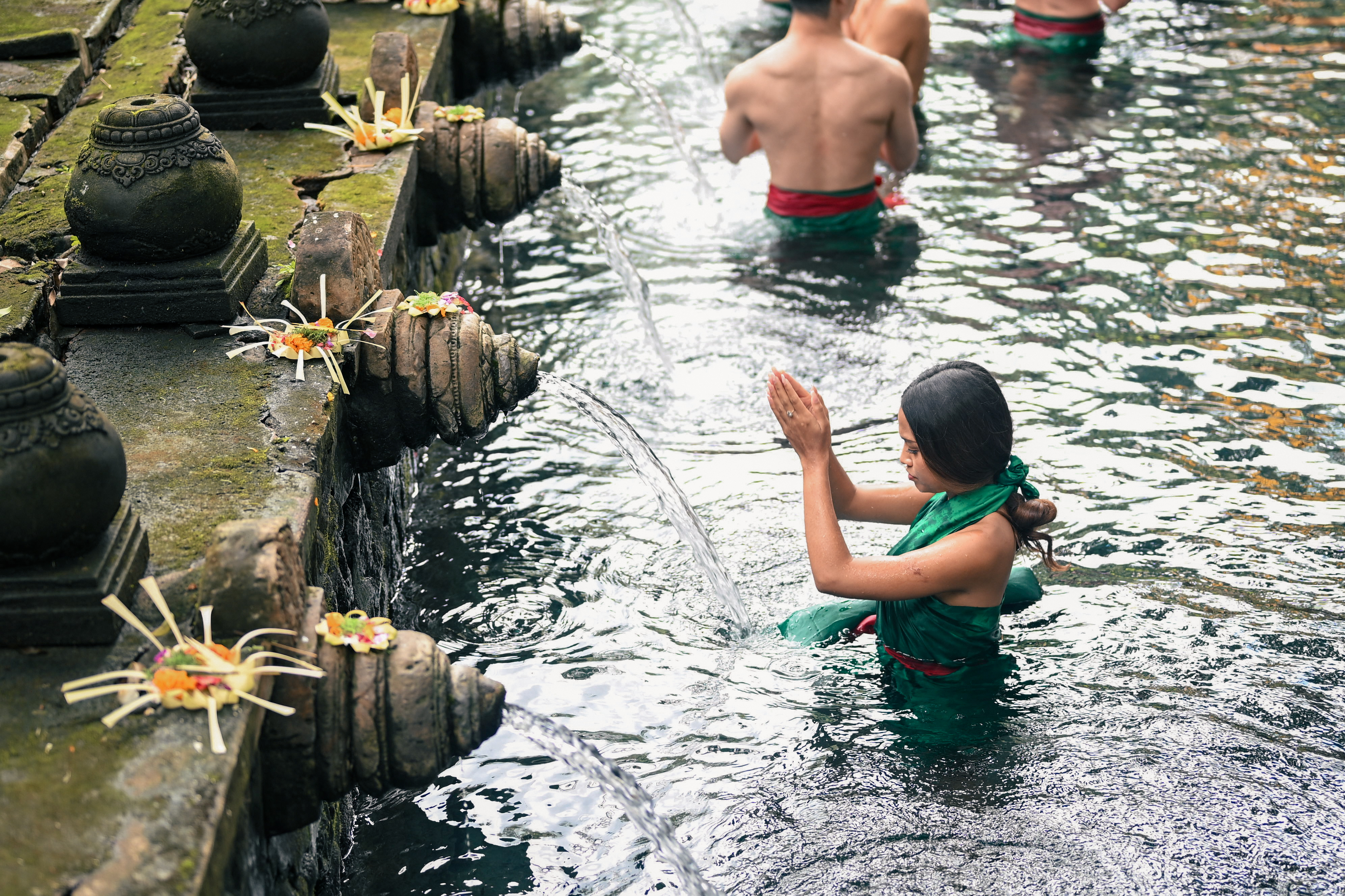 Visitor performing melukat purification at Tirta Empul holy spring
