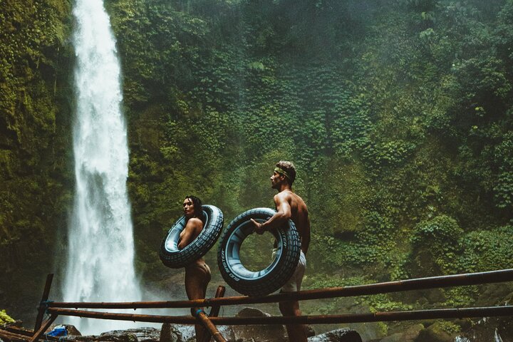 Goa Raja waterfall with cave entrance behind cascading water
