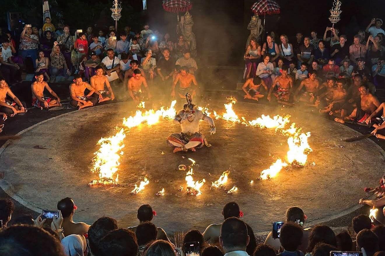 Kecak fire dance performers at Uluwatu temple sunset